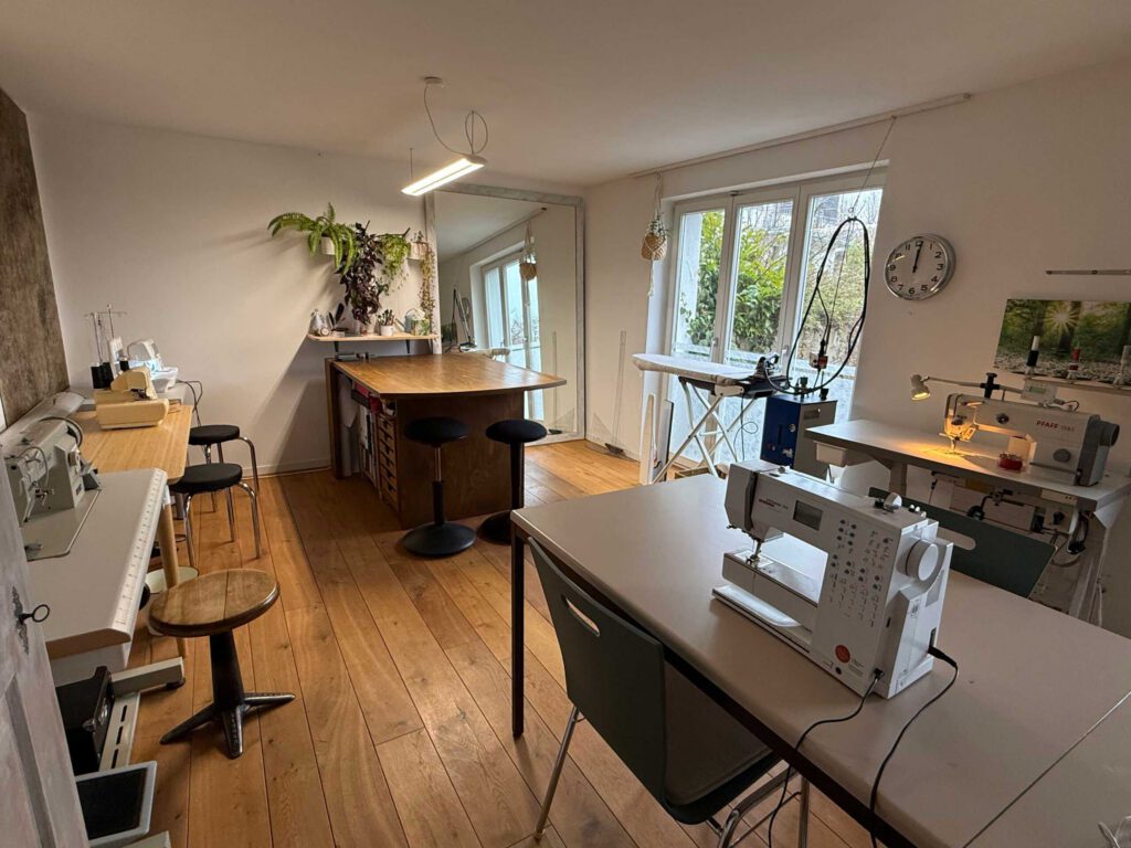 Näharbeitsplatz mit Nähmaschine im Atelier